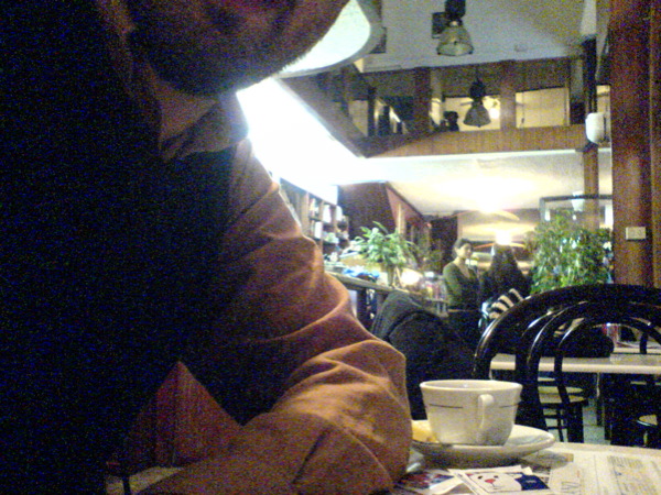 man sitting at the table eating and drinking