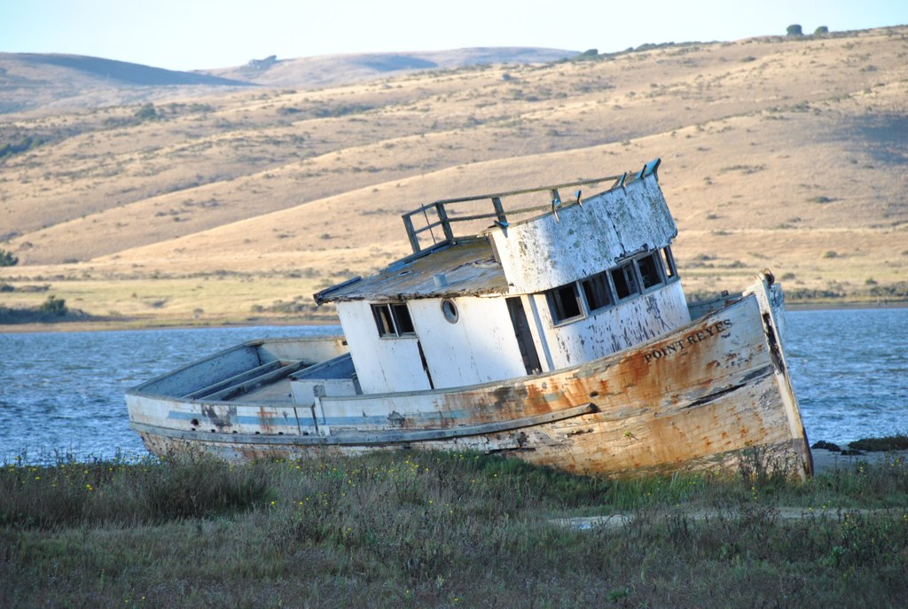 an old boat washed up on the shore