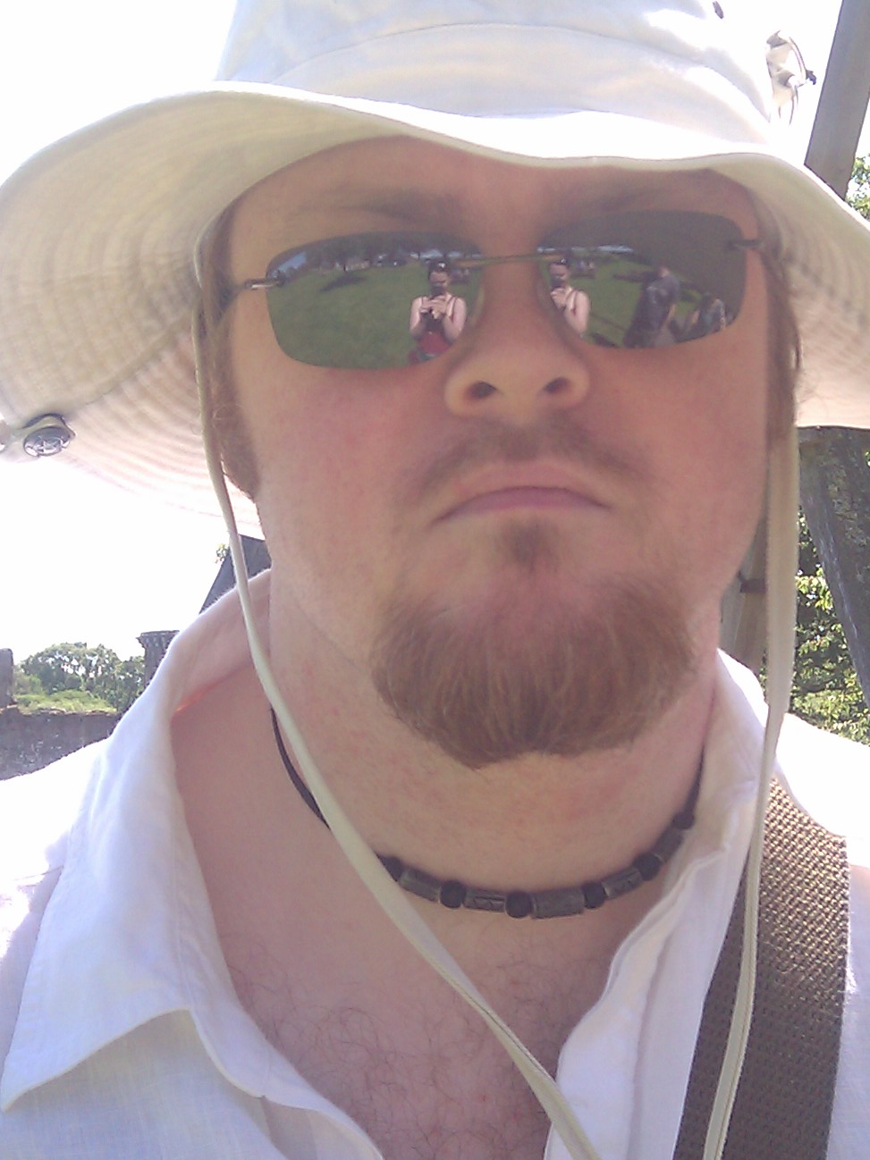 a man in sun glasses and a hat