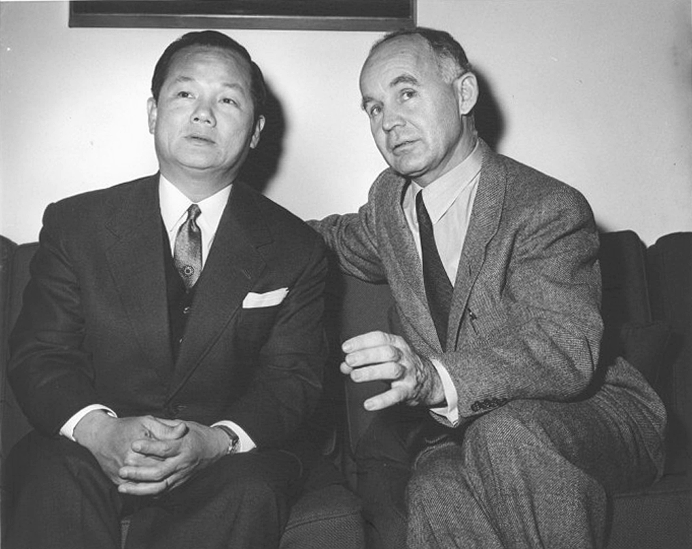 two men in suits sitting next to each other