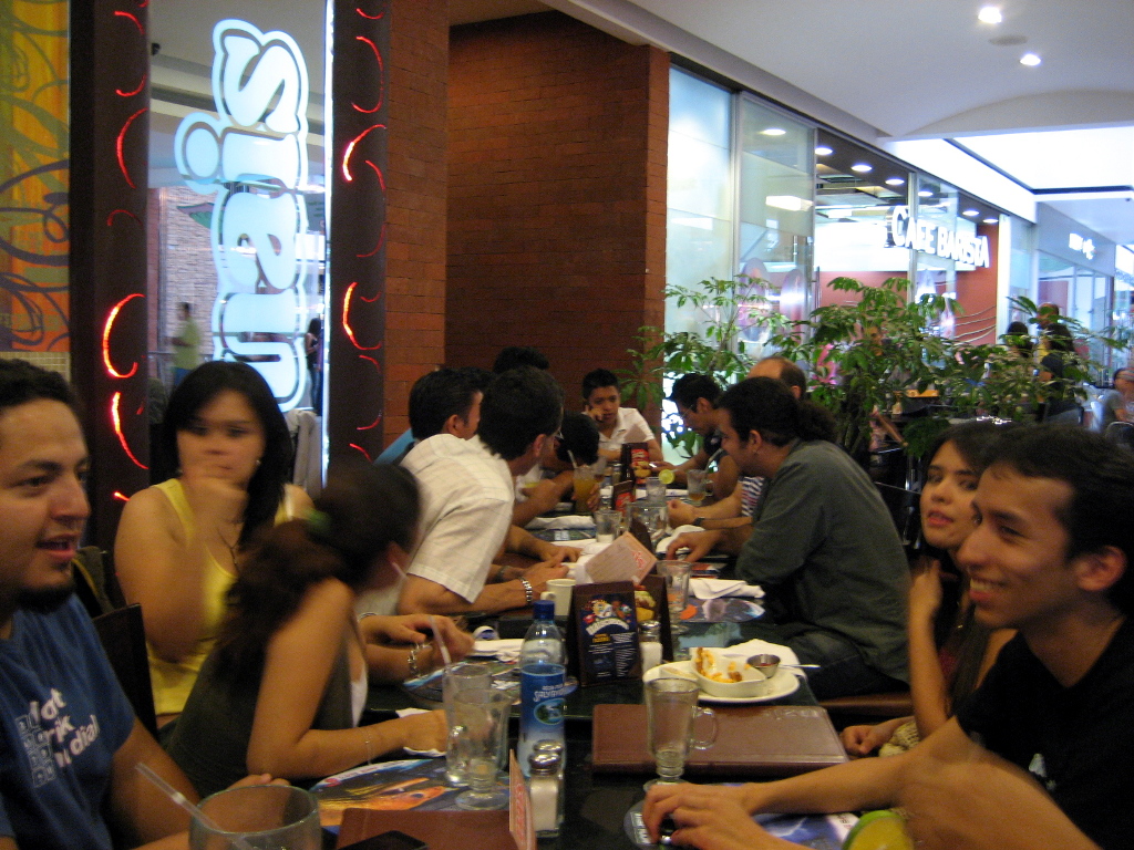 people eating a meal at a restaurant while talking