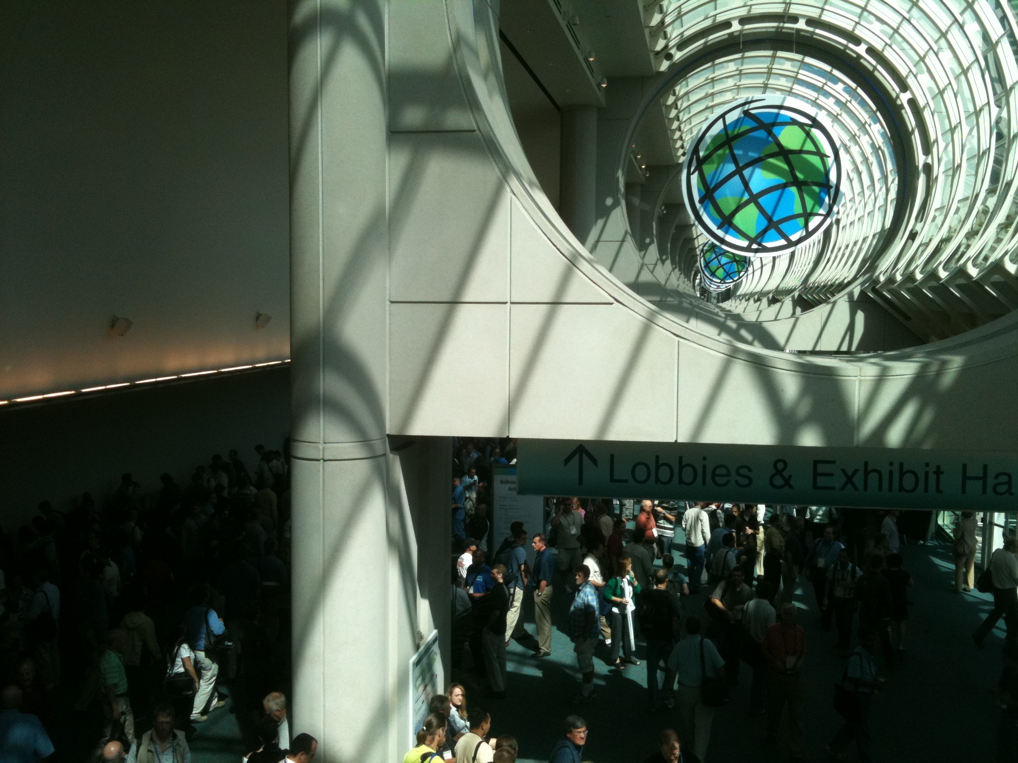 an overhead po of people walking down and one person on a cell phone