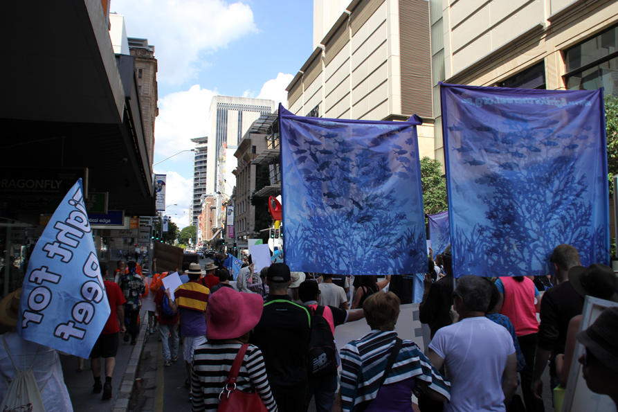 people with hats and banners walking down the street