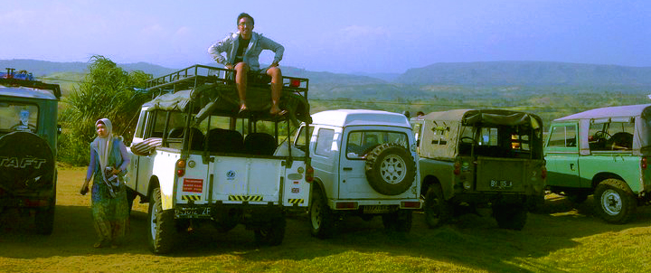 a group of jeeps with men standing on top of them