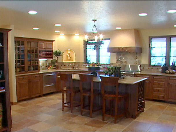a large kitchen with a table and book shelf