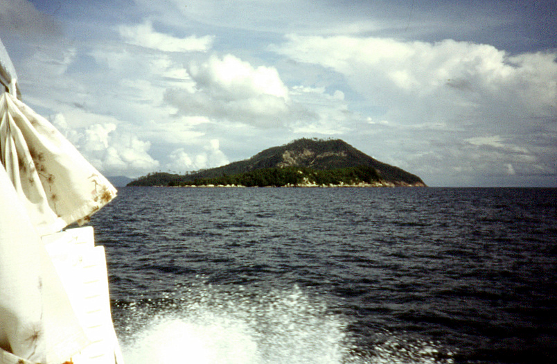 a boat on the water by a small island