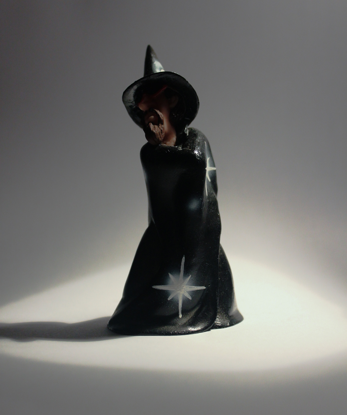a black and white ceramic figurine with the moon, stars, and the stars above