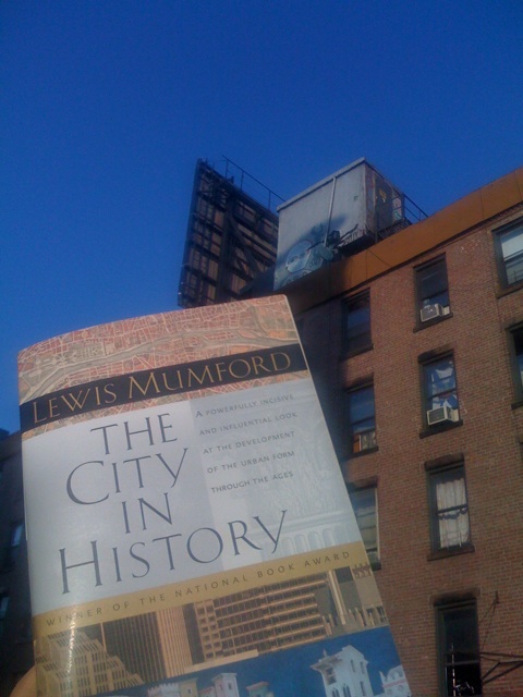 the city in history poster sitting on the side of a building