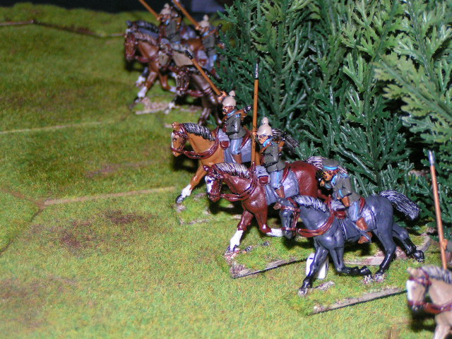a toy army with some horses next to a christmas tree