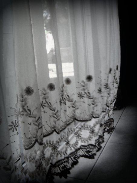 a room with flowers in the curtains