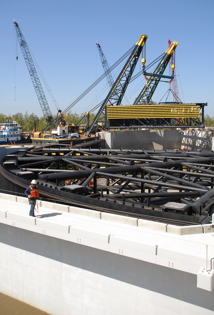 a group of cranes sitting on top of a white wall