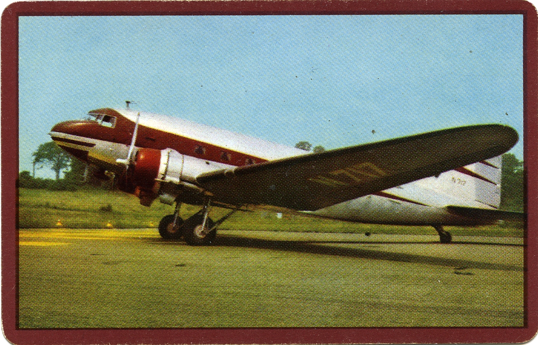 this small red and white airplane is parked on a runway