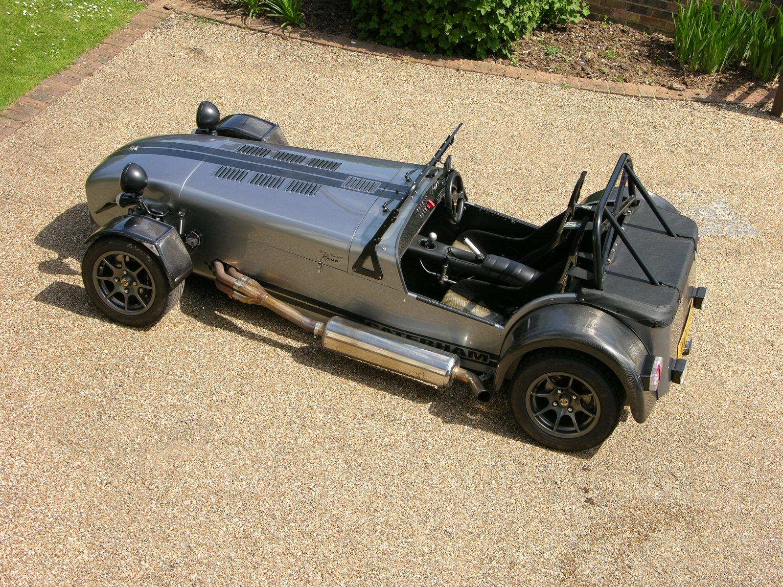 an old fashion looking car is parked in the sand