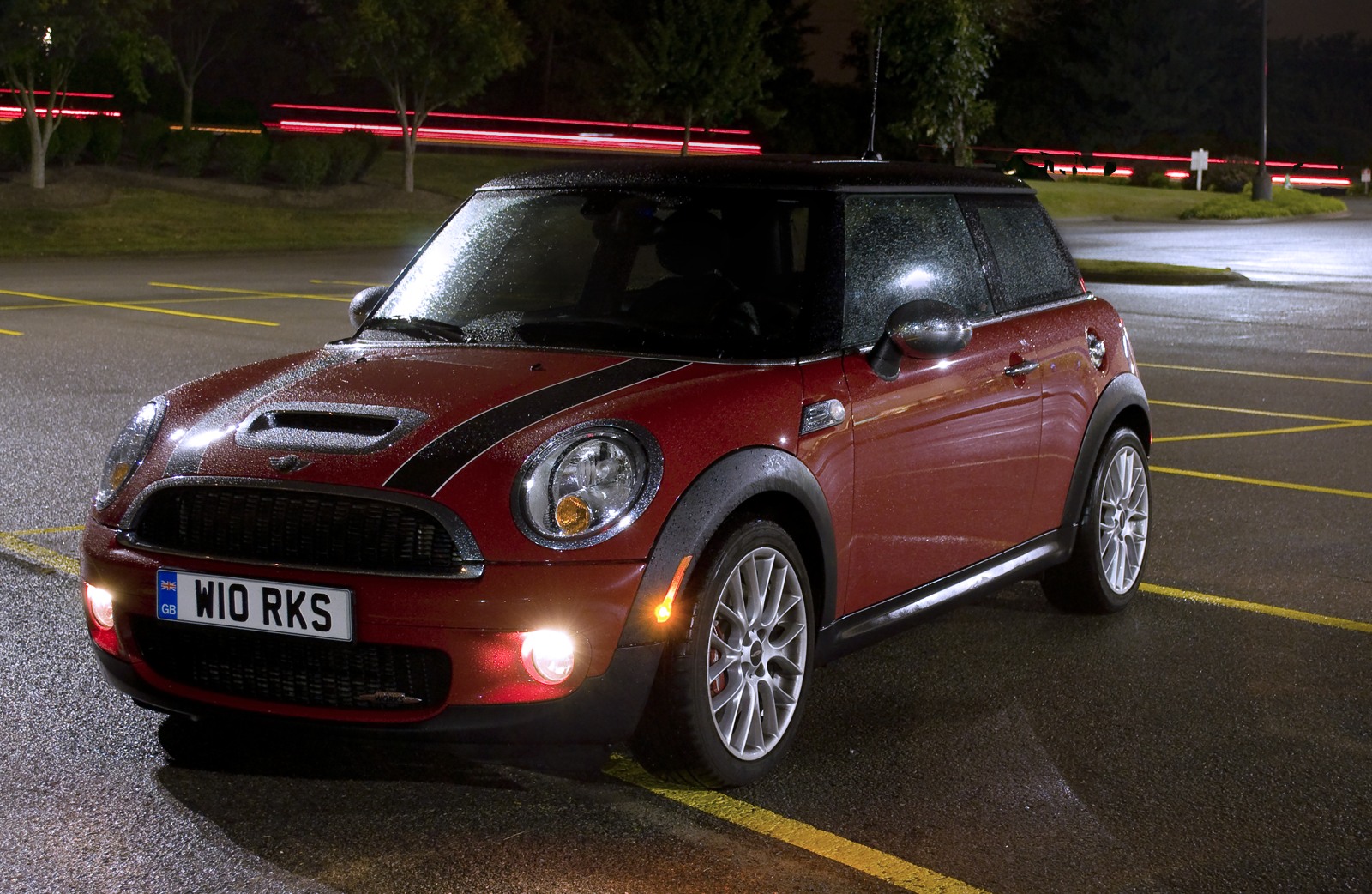 a small red car parked in a parking lot