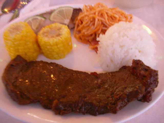 steak, rice and three vegetables are arranged on a plate