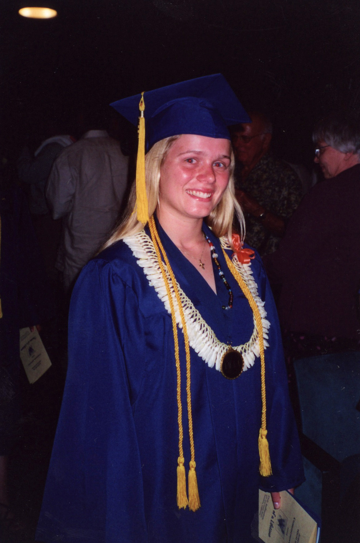 young woman in cap and gown at graduation