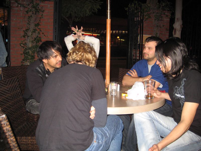 people sitting at tables having fun in the dark