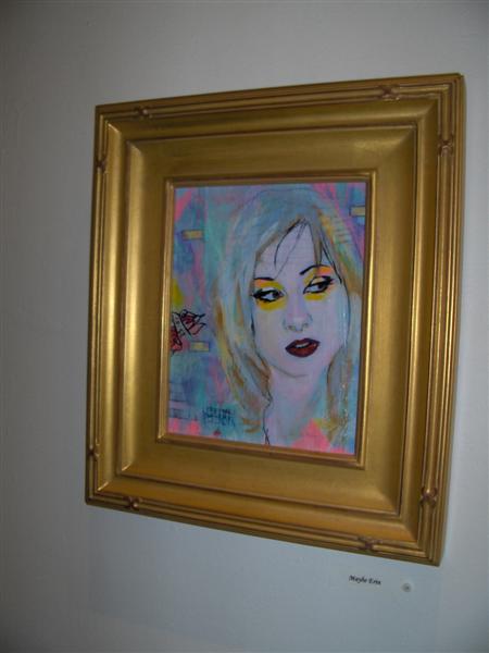 a painting of a woman's face on a wall