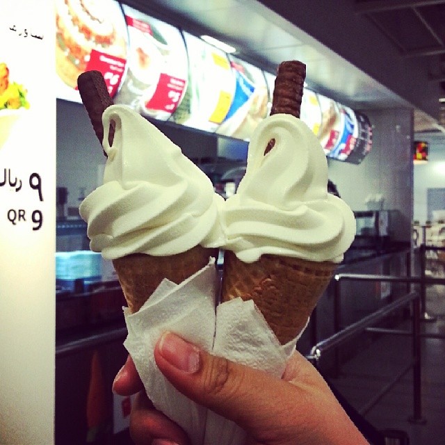 two ice cream cones sitting on top of each other