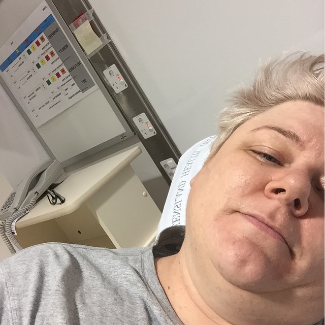 a woman laying on top of a hospital bed