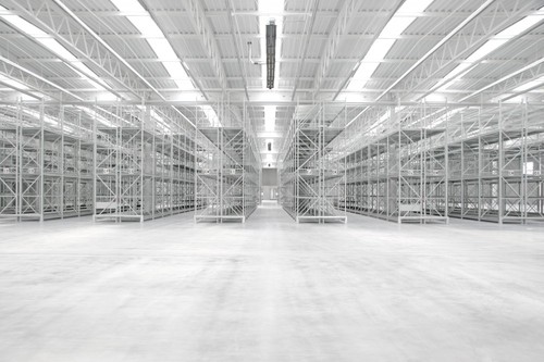 an empty industrial warehouse with lots of shelves