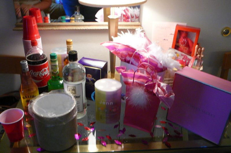 a bar cluttered with gifts, bottles, and other things