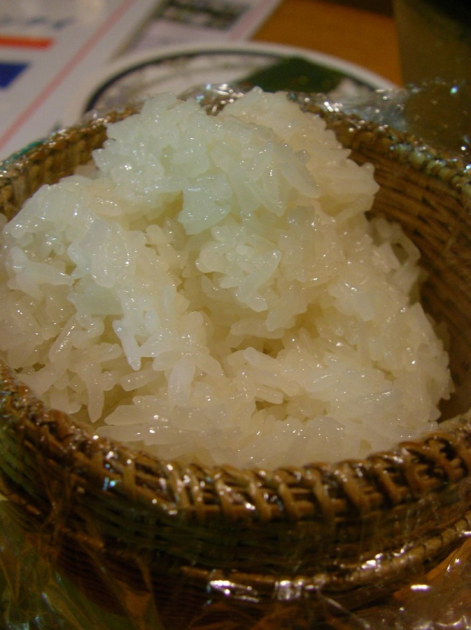 a close up of a small basket with rice in it