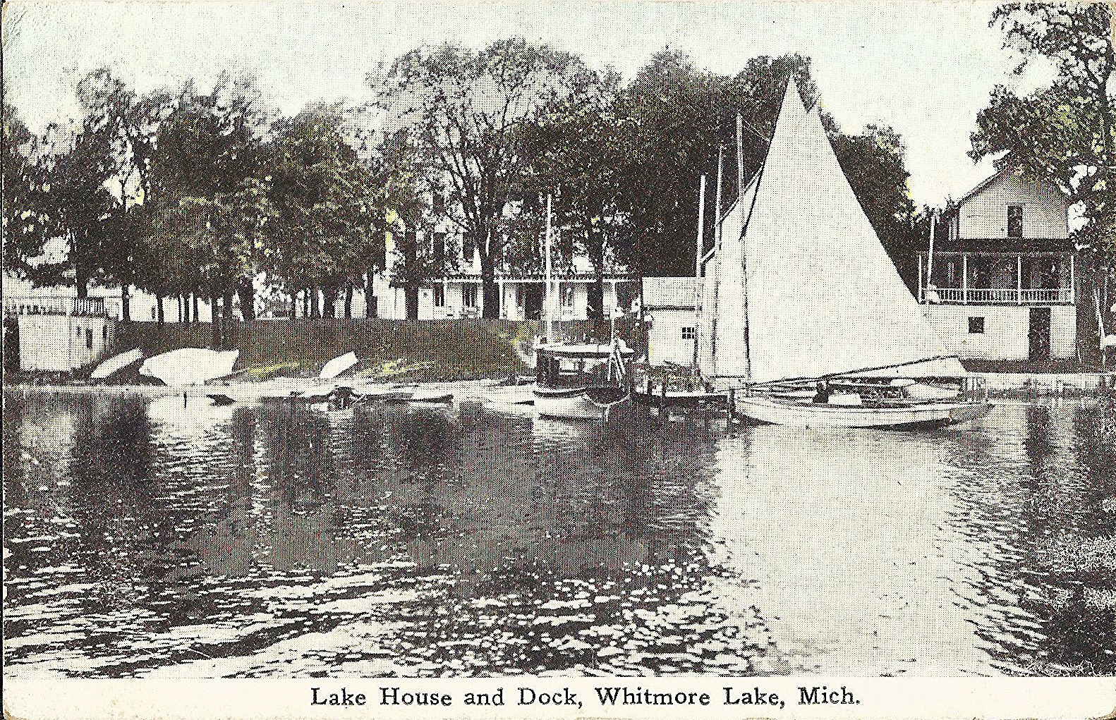 a small sail boat is shown near water