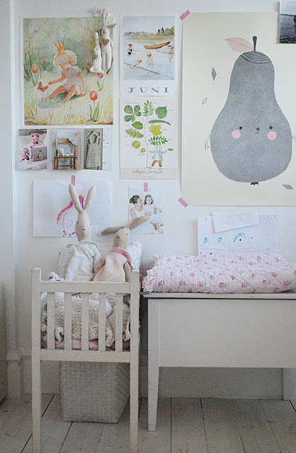 white bedroom with wall art and decor including a white crib