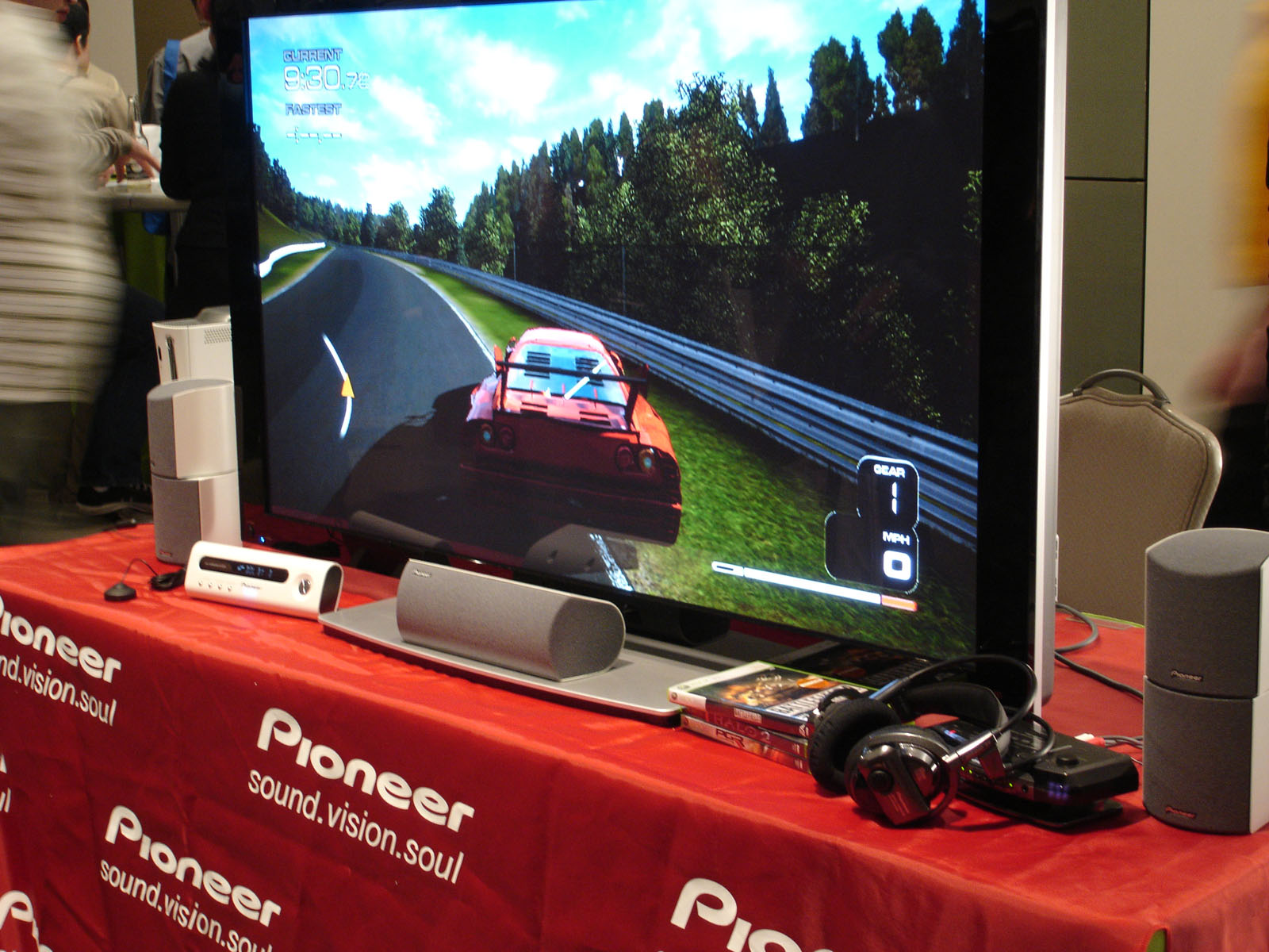 a man is playing a video game with two speakers