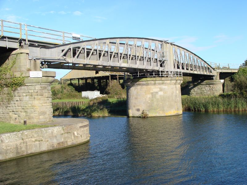 a bridge over a river that has two tall buildings