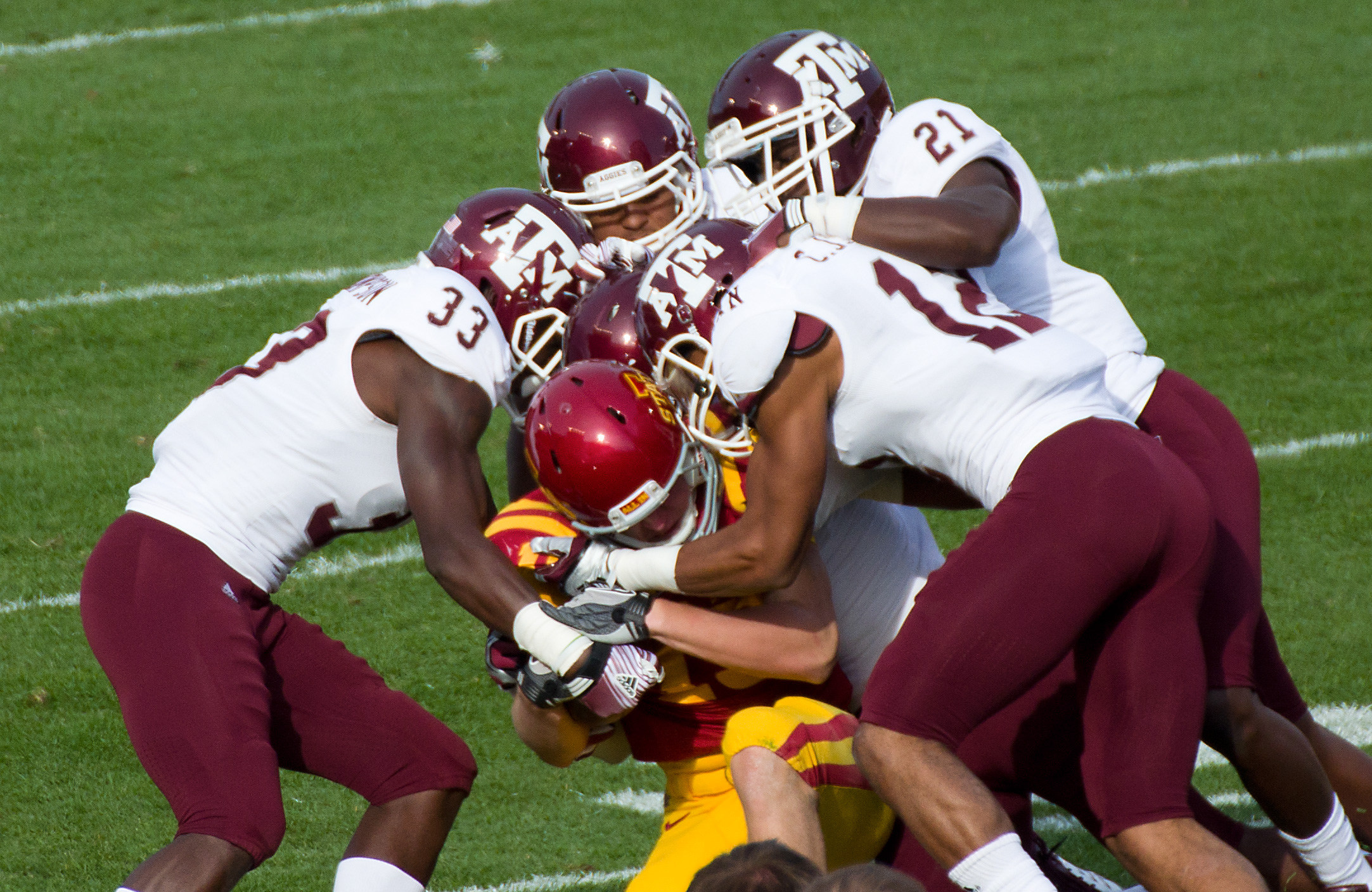 four people on field playing with each other