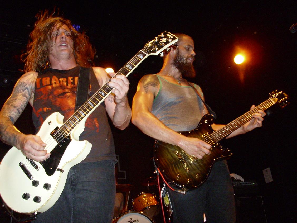 two guys with guitar guitars on the stage