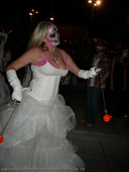 a woman dressed up with many costumes at a costume competition