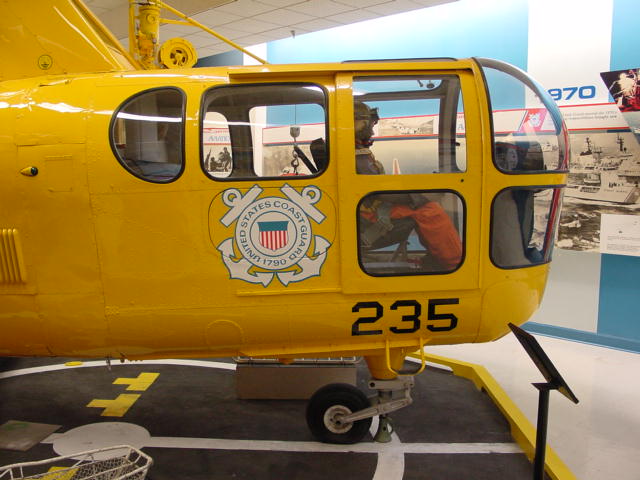 yellow police helicopter parked on display in museum