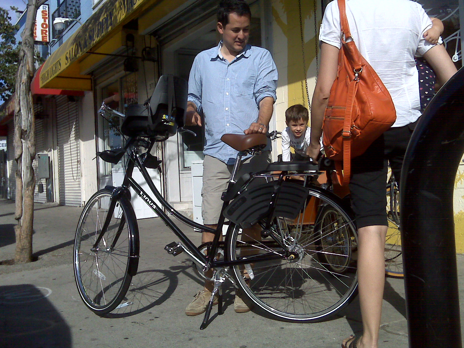 two men standing next to a parked bicycle