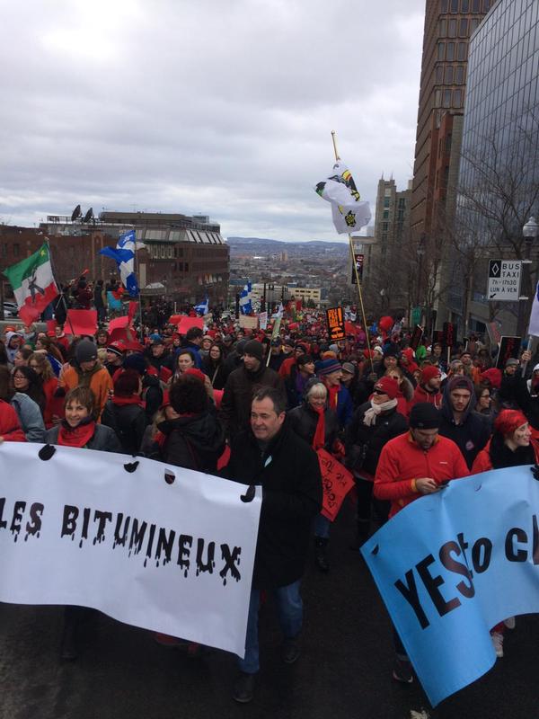 people holding signs in the street during an anti - homosexuality march