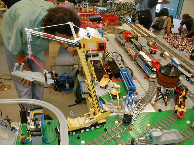 a person standing next to some toy trains and tracks