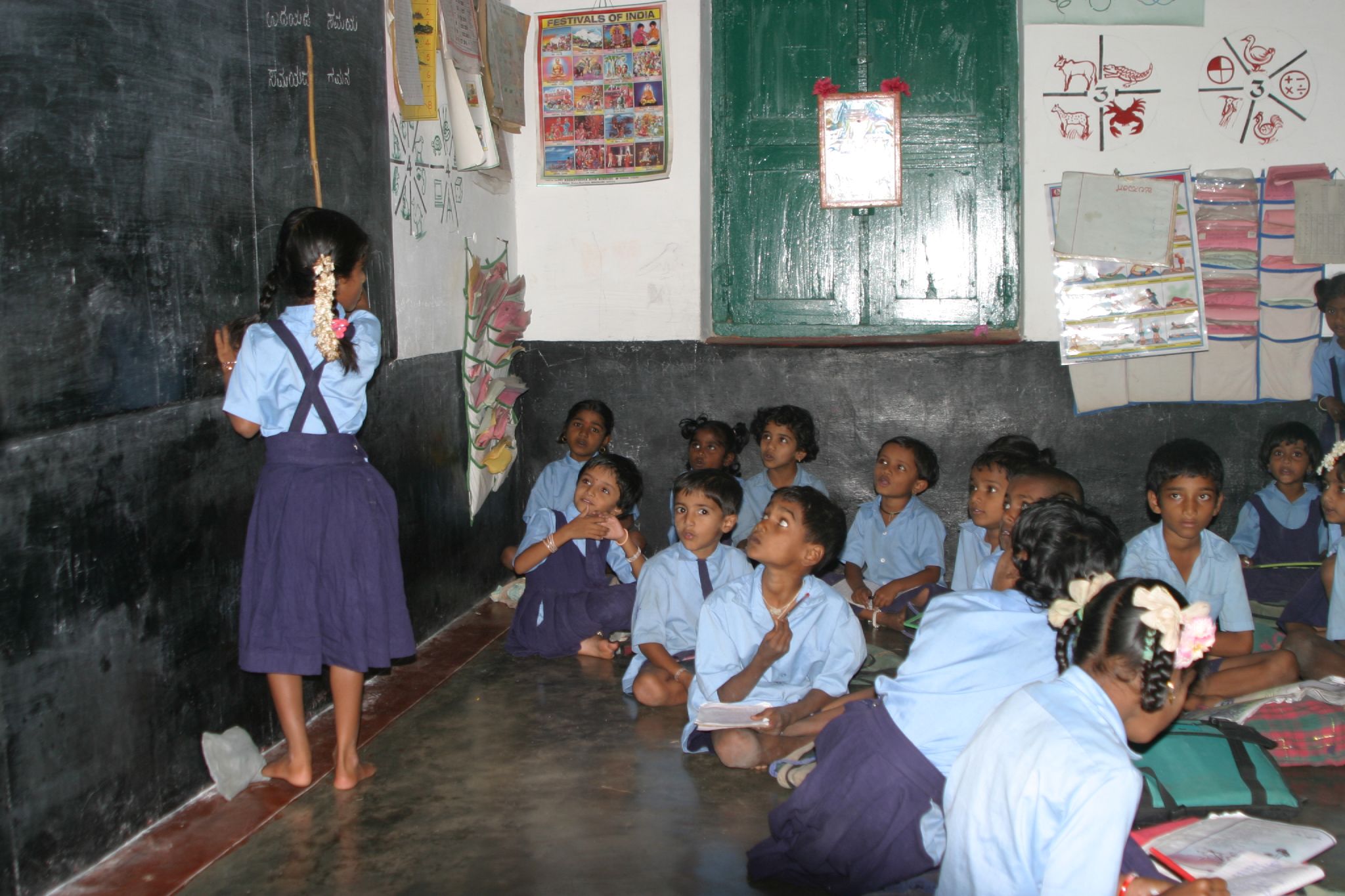 a woman teaching in school while other watch