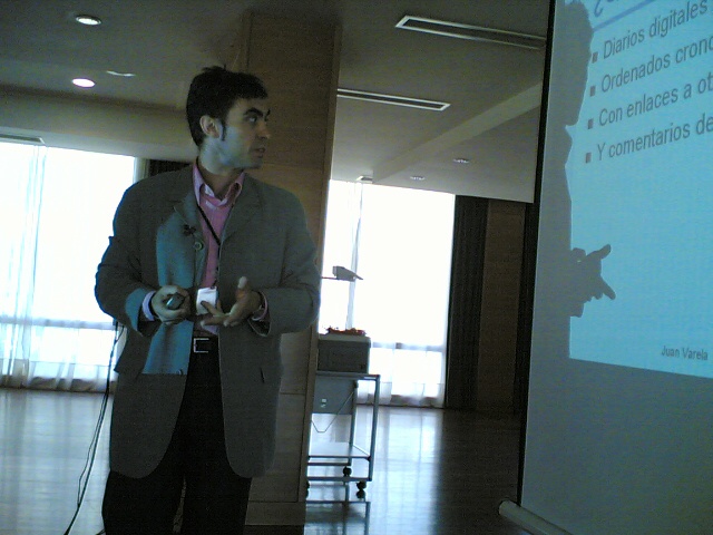 a man is giving a presentation at the front of a room