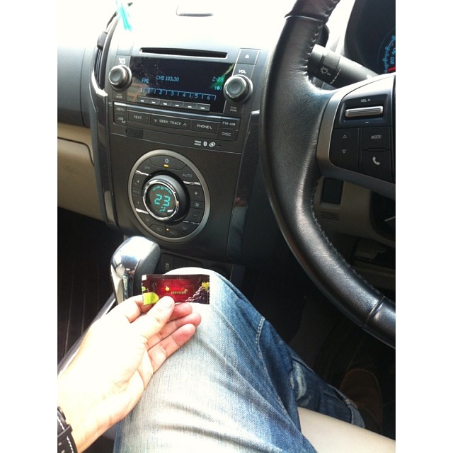 a person is holding a small device while inside a car