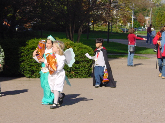 a group of people in costumes walking on the road