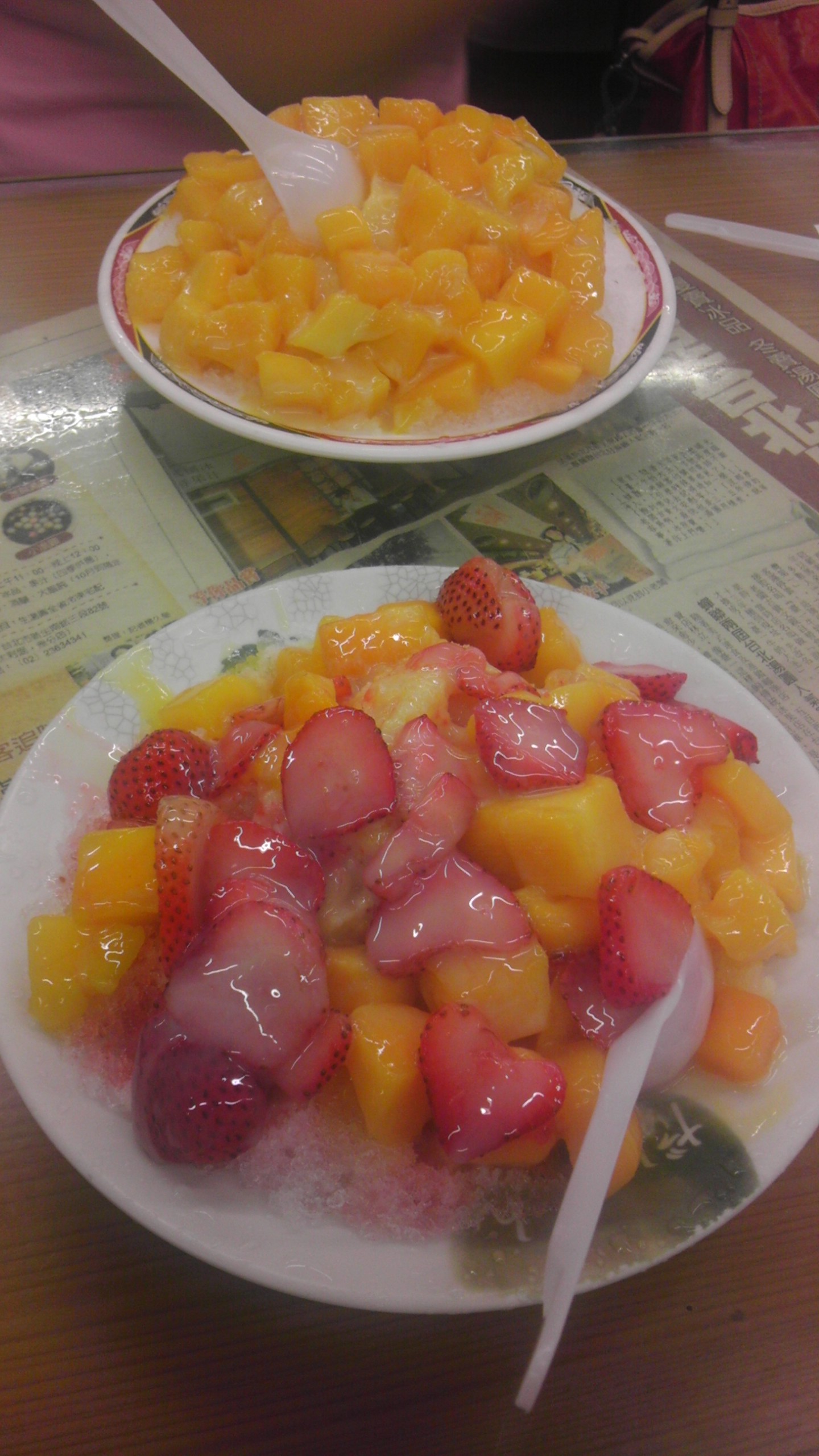 two plates that have fruit on them sitting on a table