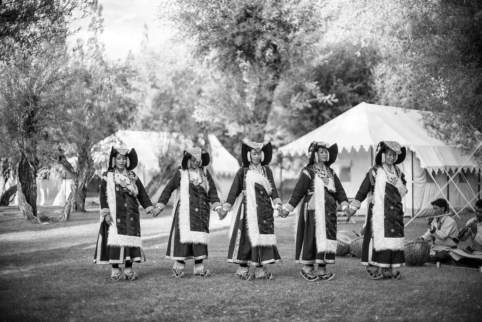 three native americans are dancing with their sticks