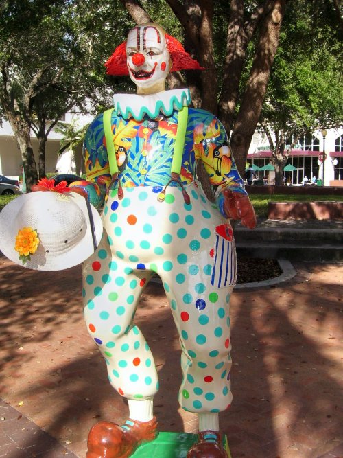 there is a statue of a clown riding a skateboard