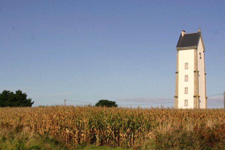 a big tall building in the middle of a field