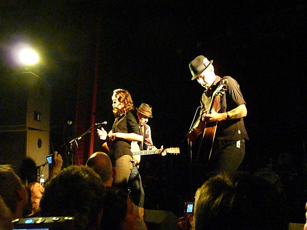 two musicians on stage in front of a crowd