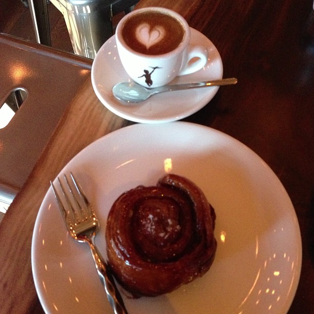 plate with a pastry and cup of coffee