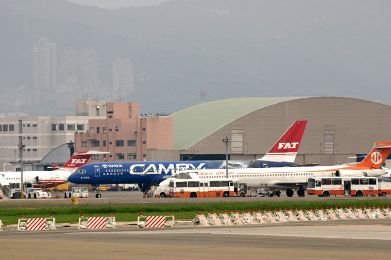 large commercial jet airplanes lined up on the tarmac