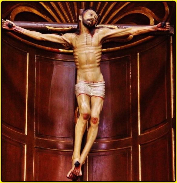 the crucifix is adorned with  dripping across the bottom